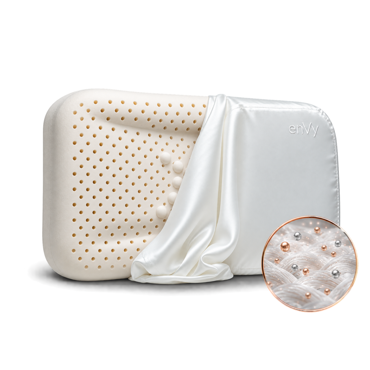 A white silk pillowcase draped over it, featuring a circular inset showing the COPPER and ZINC infused into the silk pillowcase of the enVy®  pillow