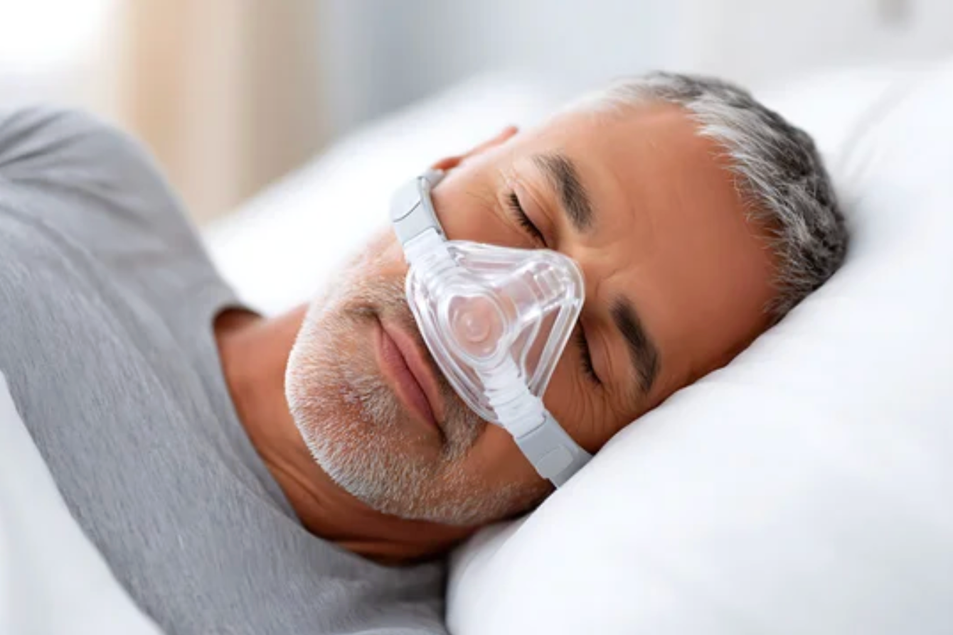 Man sleeping with a CPAP mask on his face